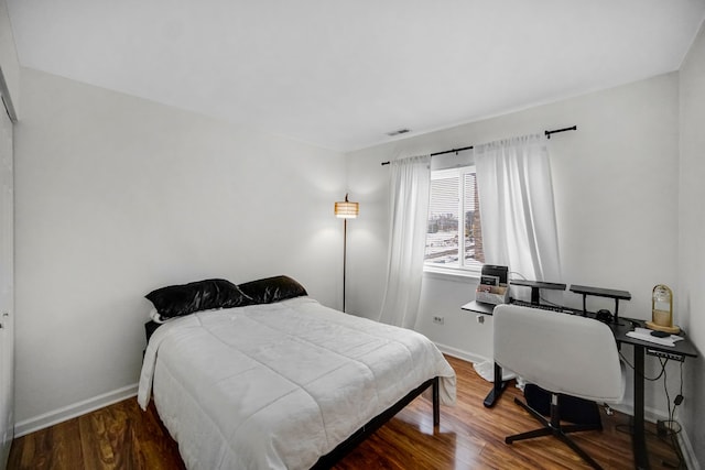 bedroom with wood-type flooring