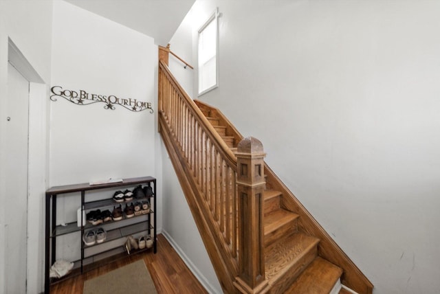 stairs featuring wood-type flooring