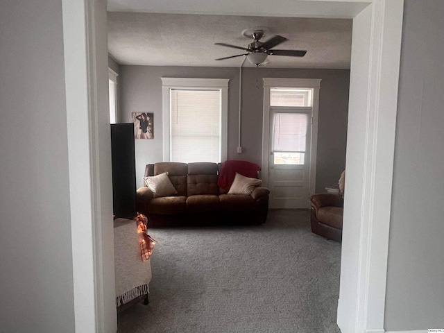 living room with carpet floors and ceiling fan