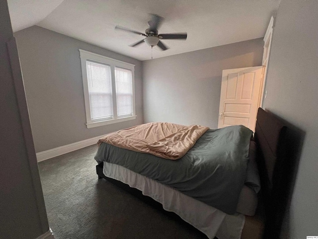 carpeted bedroom featuring ceiling fan and vaulted ceiling