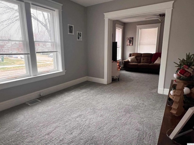 carpeted spare room with ceiling fan