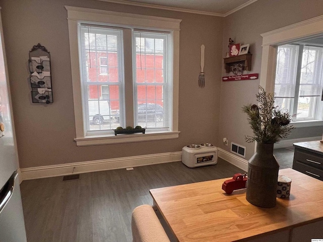 dining space featuring dark wood-type flooring and ornamental molding