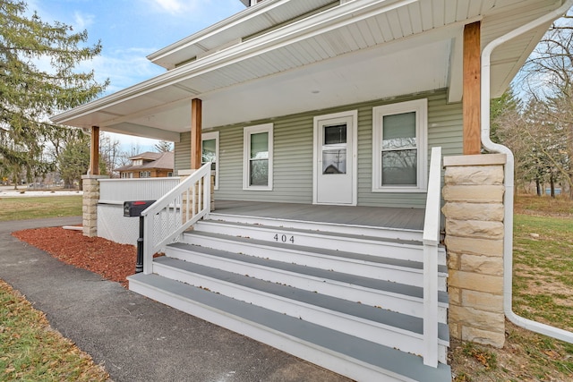 entrance to property featuring covered porch