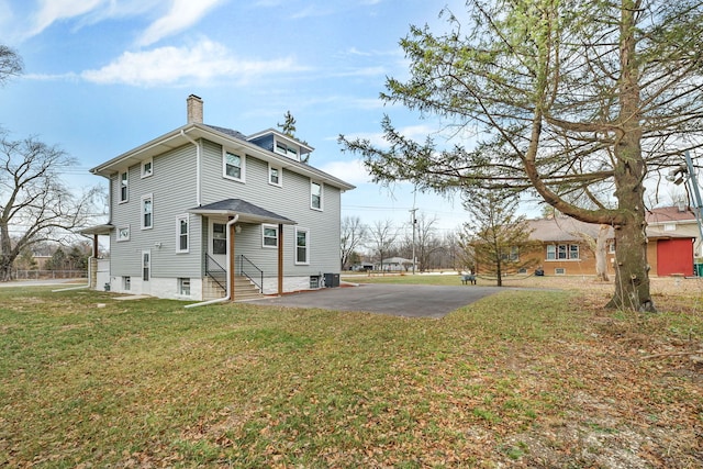 back of property featuring a yard and central AC unit