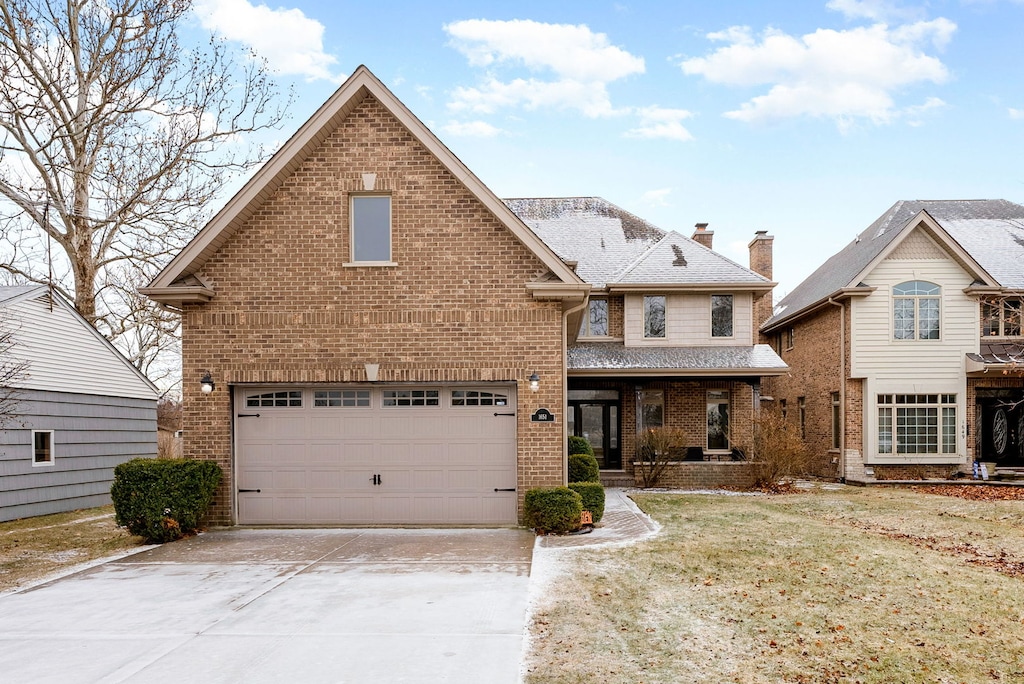 front facade featuring a front lawn and a garage