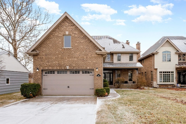 front facade featuring a front lawn and a garage