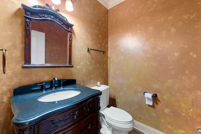 bathroom with vanity, toilet, and crown molding