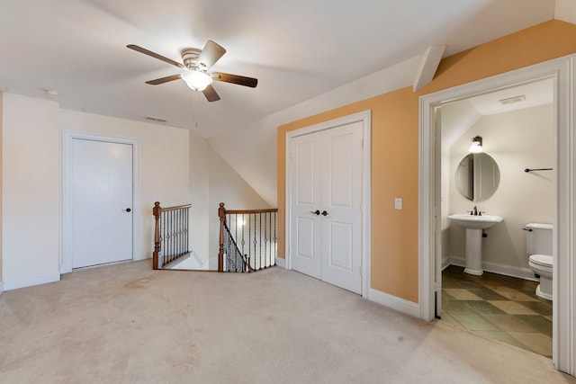 additional living space with ceiling fan, light colored carpet, and lofted ceiling