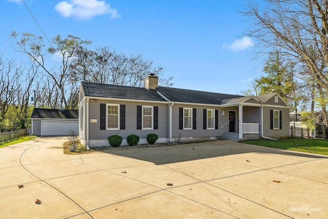 ranch-style house with a garage and an outdoor structure