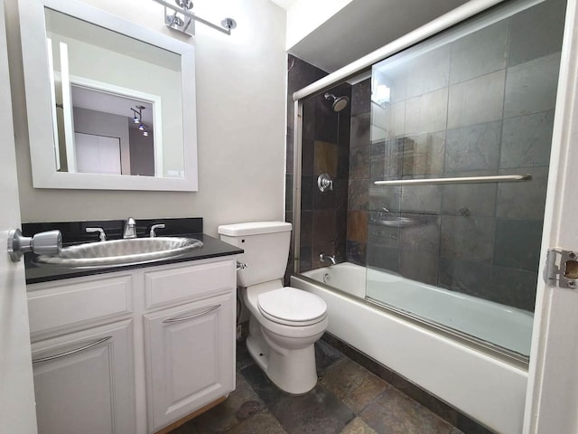 full bathroom with vanity, toilet, and bath / shower combo with glass door