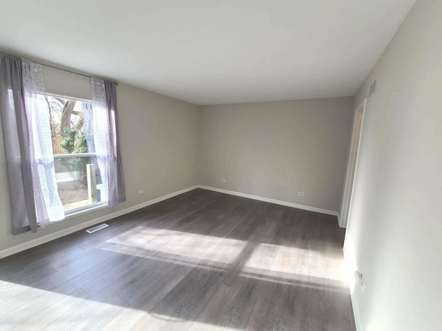 empty room with dark hardwood / wood-style floors