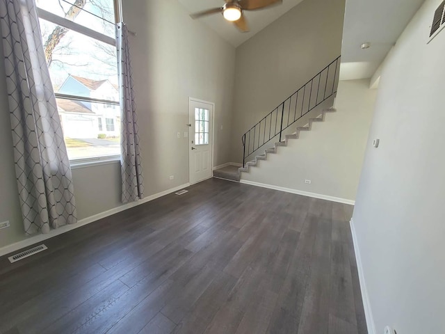 entryway featuring dark wood-type flooring, ceiling fan, and a healthy amount of sunlight