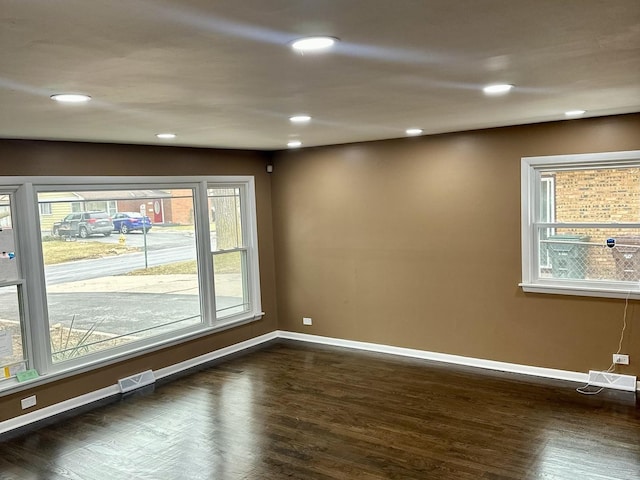 unfurnished room with dark hardwood / wood-style flooring