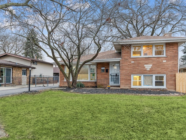 tri-level home with a front yard