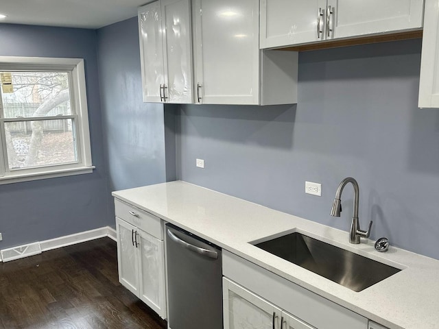 kitchen with stainless steel dishwasher, white cabinets, dark hardwood / wood-style floors, and sink