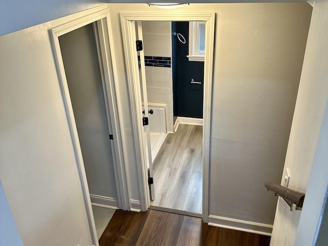 hallway with hardwood / wood-style floors