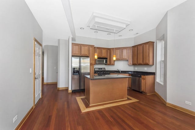 kitchen featuring dark hardwood / wood-style flooring, stainless steel appliances, a kitchen island, and sink