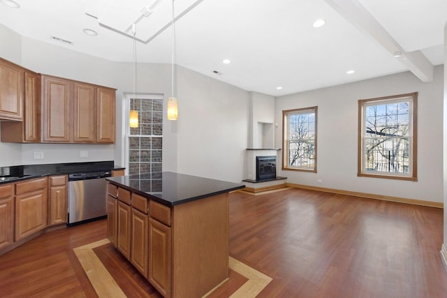 kitchen with stainless steel dishwasher, decorative light fixtures, a center island, and hardwood / wood-style flooring