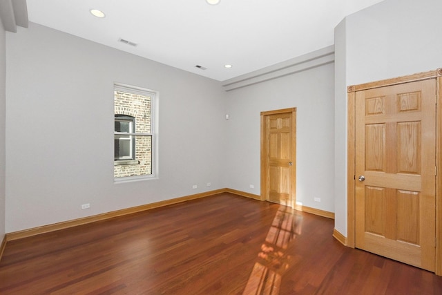 spare room featuring dark hardwood / wood-style flooring