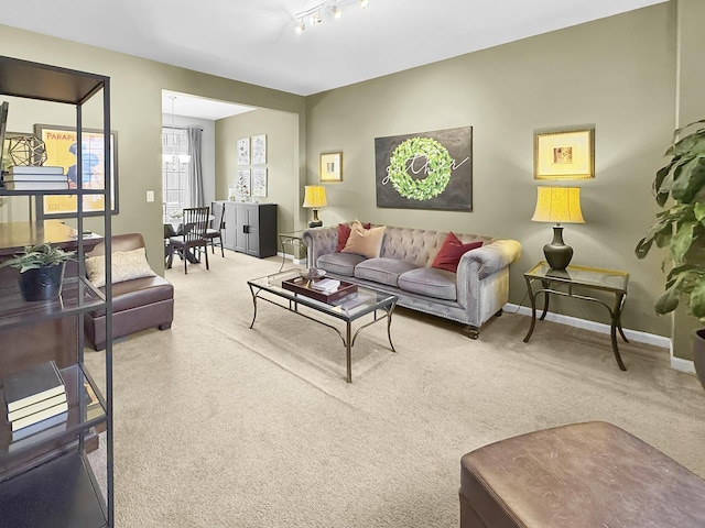 carpeted living room featuring rail lighting