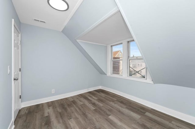 bonus room featuring dark hardwood / wood-style flooring and vaulted ceiling