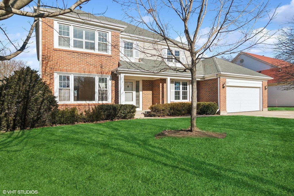 view of front of house with a front yard and a garage