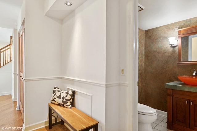 bathroom featuring toilet, vanity, and tile patterned flooring