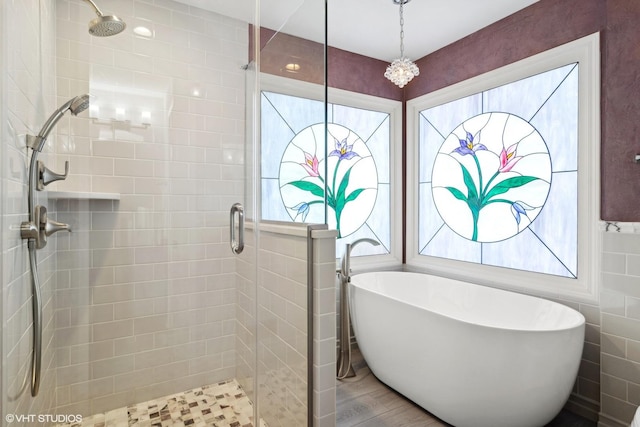 bathroom with separate shower and tub and hardwood / wood-style floors