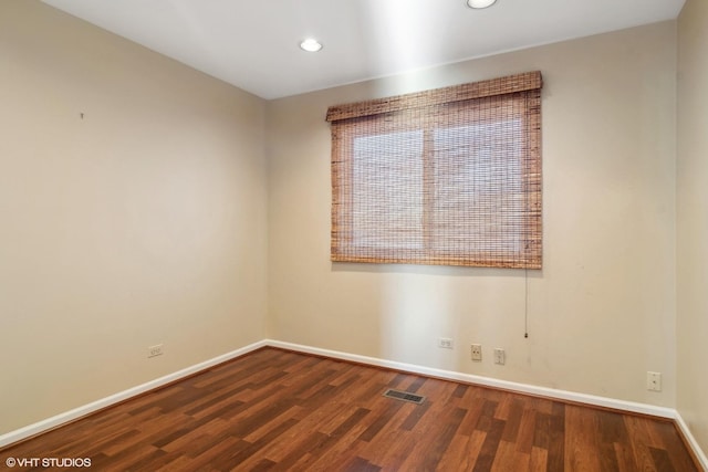 unfurnished room featuring dark hardwood / wood-style flooring