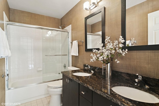 full bathroom featuring toilet, tile patterned flooring, enclosed tub / shower combo, and vanity