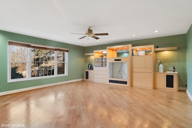 unfurnished living room featuring ceiling fan and hardwood / wood-style floors