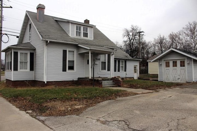 view of front of home with an outdoor structure and a garage