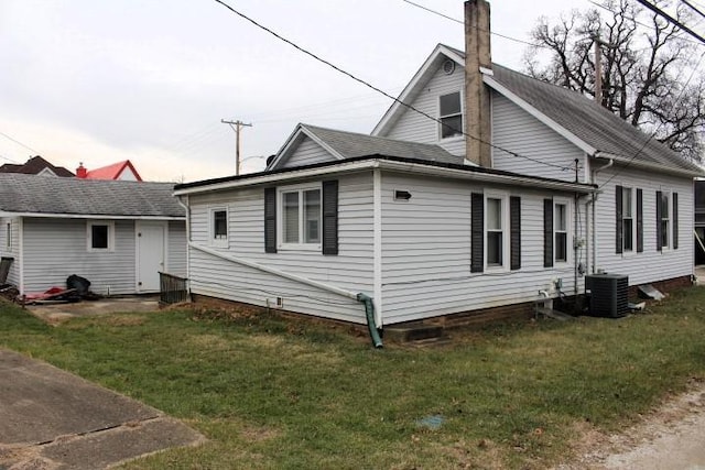 back of house with a yard and cooling unit