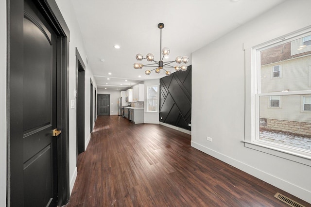 interior space with recessed lighting, a notable chandelier, visible vents, baseboards, and dark wood-style floors