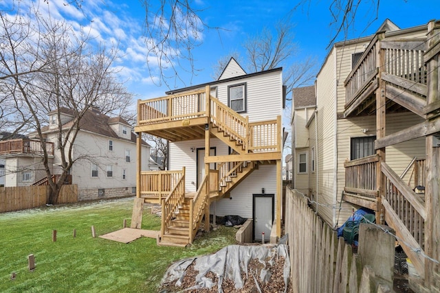 back of house with a deck, a yard, stairway, and fence