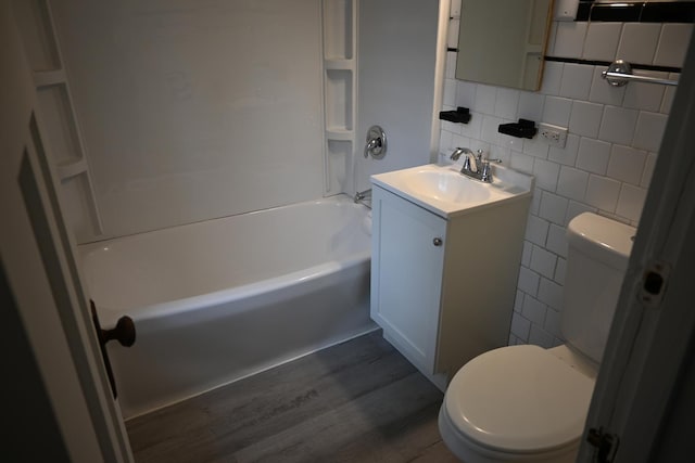 full bathroom with tile walls, backsplash, vanity, toilet, and tub / shower combination