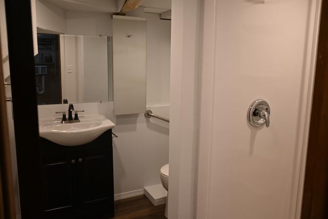 bathroom with vanity, hardwood / wood-style flooring, and toilet