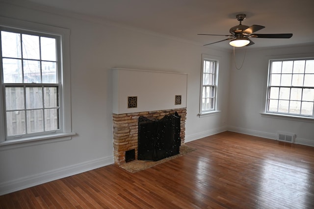 unfurnished living room with crown molding, a fireplace, ceiling fan, and hardwood / wood-style flooring