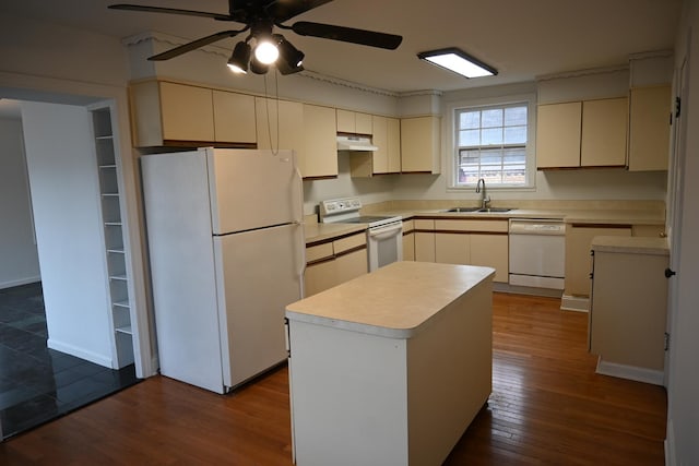 kitchen featuring sink, white appliances, a kitchen island, dark hardwood / wood-style flooring, and cream cabinetry