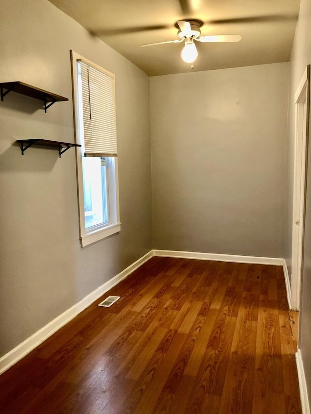 empty room with hardwood / wood-style floors and ceiling fan