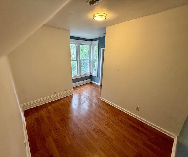 additional living space featuring hardwood / wood-style floors