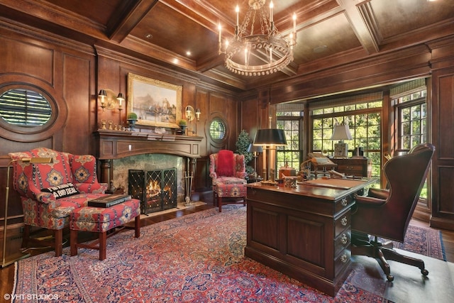 office with coffered ceiling, wooden walls, a fireplace, crown molding, and beam ceiling