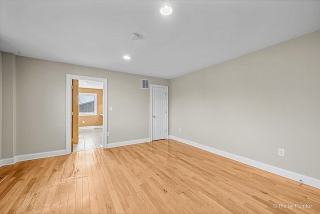 spare room featuring light wood-type flooring