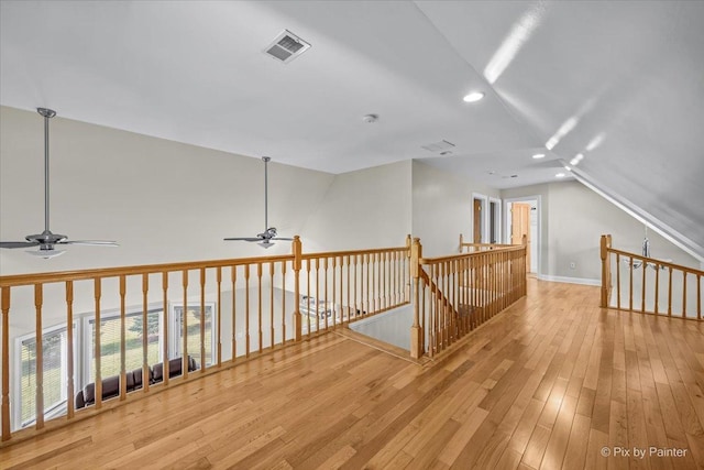 additional living space featuring ceiling fan, light hardwood / wood-style floors, and vaulted ceiling