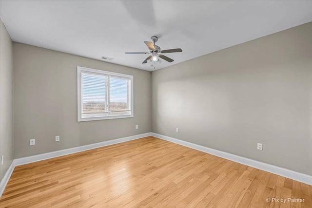 spare room featuring light wood-type flooring and ceiling fan