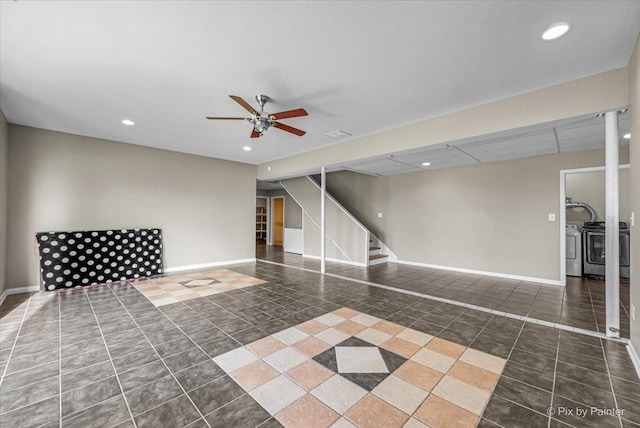 basement featuring dark tile patterned flooring and ceiling fan