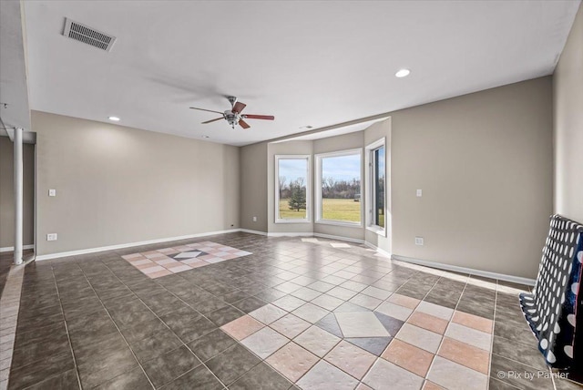 tiled spare room featuring ceiling fan