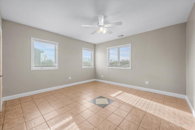 tiled empty room with ceiling fan