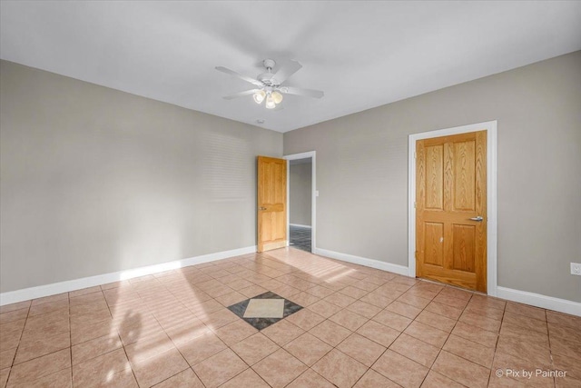 unfurnished room featuring ceiling fan and light tile patterned floors