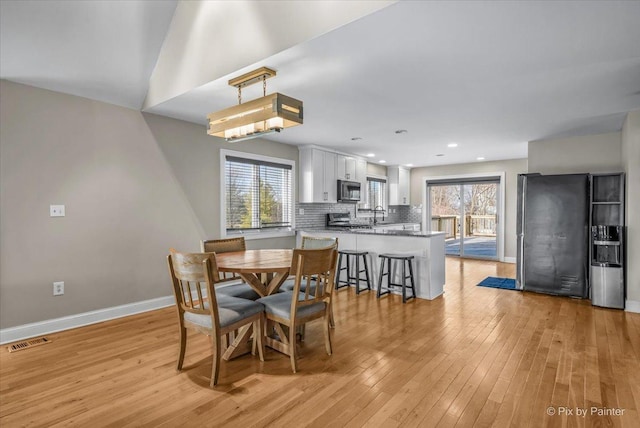 dining area featuring light hardwood / wood-style floors and sink